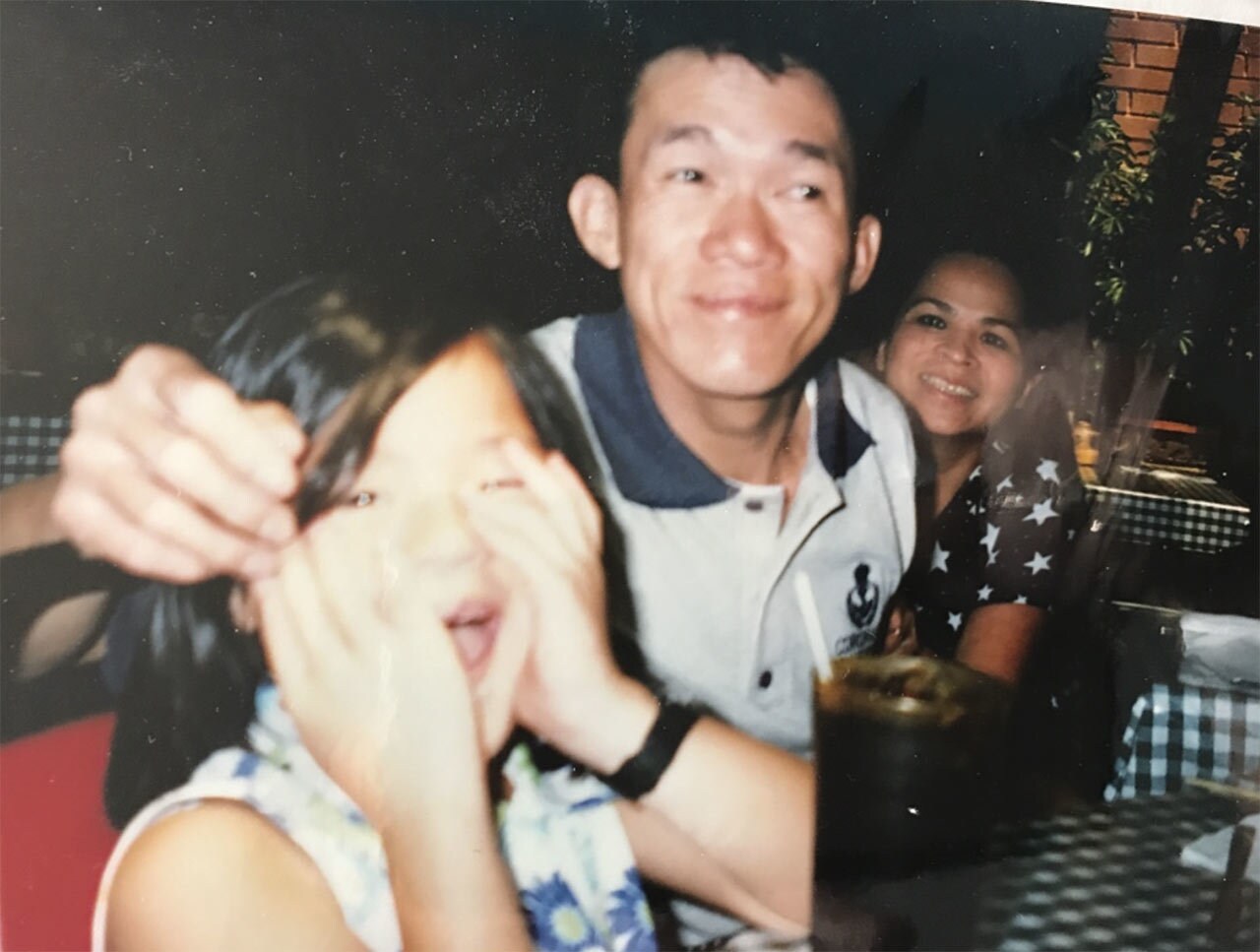 A young picture of Kelly Marie Tran with her parents.