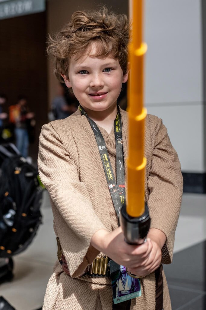 youngling holding lightsaber
