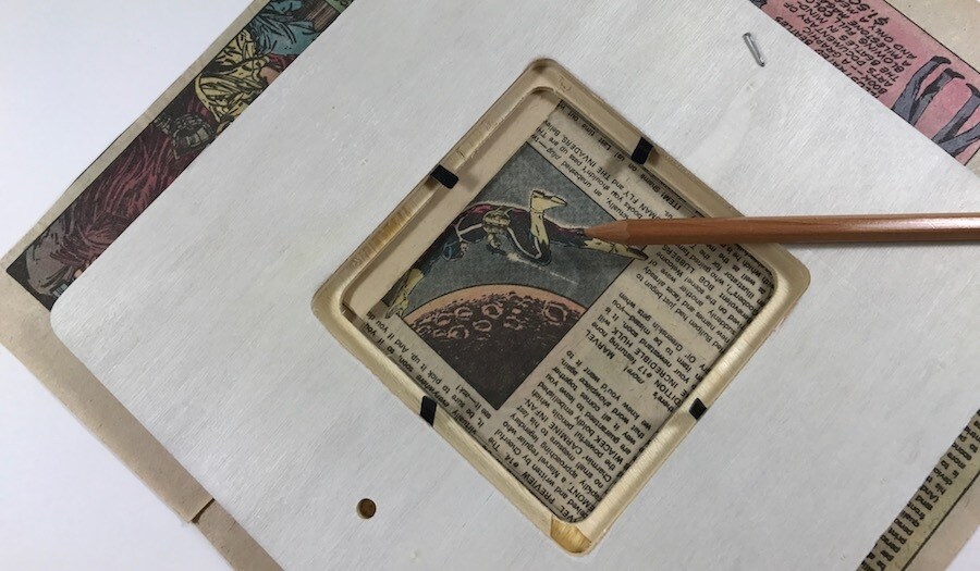 A wooden picture frame on top of a page from a comic book.
