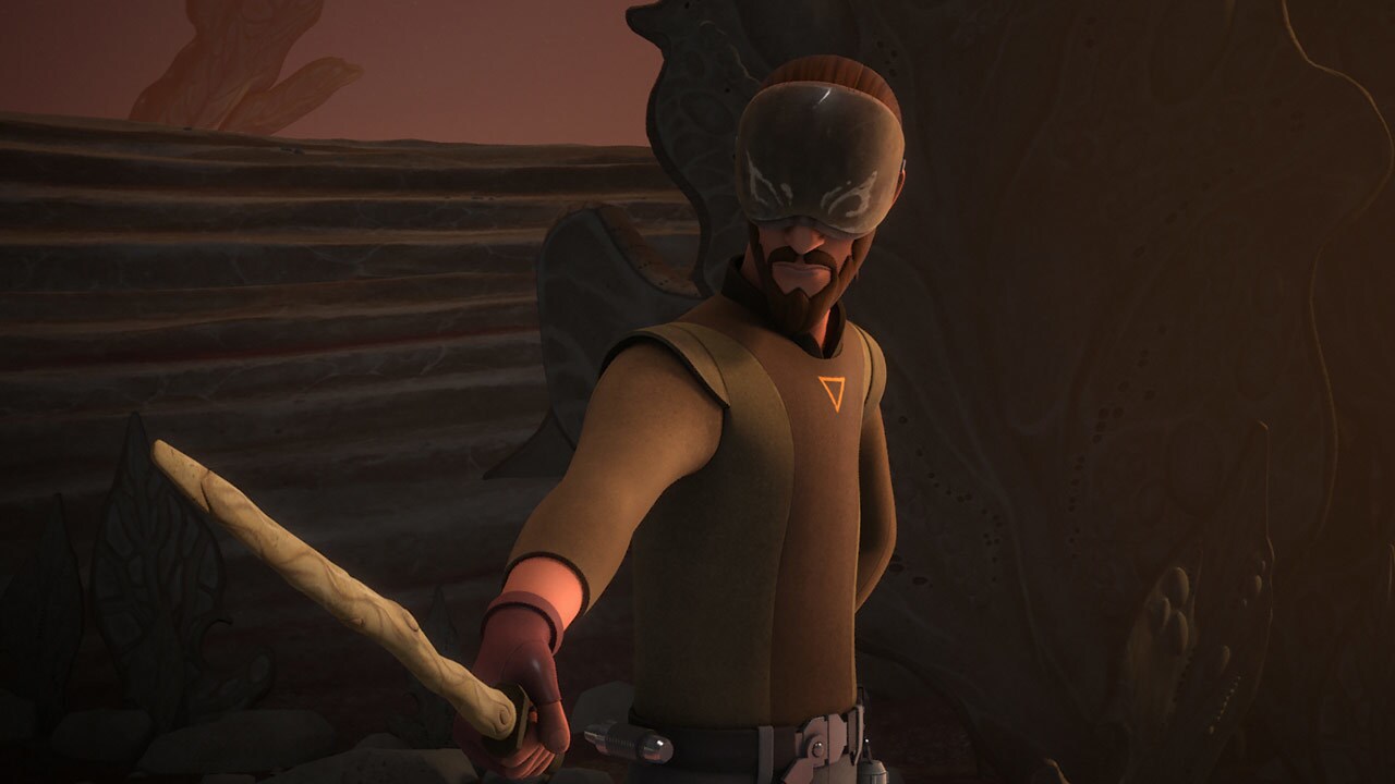 Kanan wears an eye shield as he wields a weapon in Star Wars Rebels.