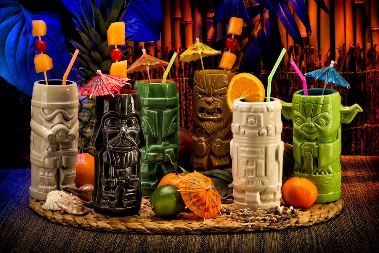 A group of Star Wars themed tiki mugs with umbrellas and garnishes. They include Darth Vader, Boba Fett, Chewbacca, and Yoda.