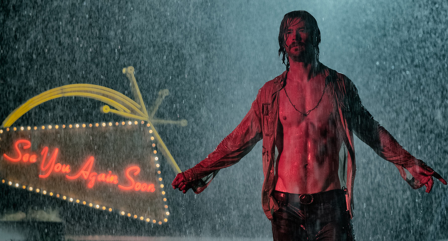 Actor Chris Hemsworth (as Billy Lee) standing in the rain  in the movie " Bad Times At The El Royale"