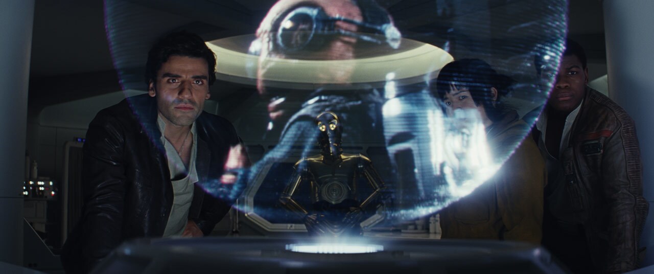 Poe Dameron looks at a holograph display in The Last Jedi.