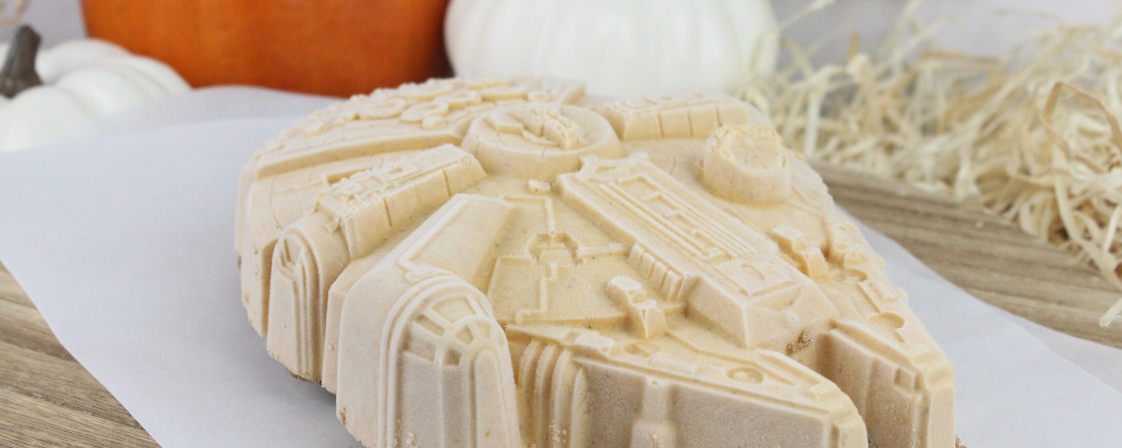 A pumpkin spice Millennium Falcon-shaped ice cream dessert as displayed in a holiday setting.
