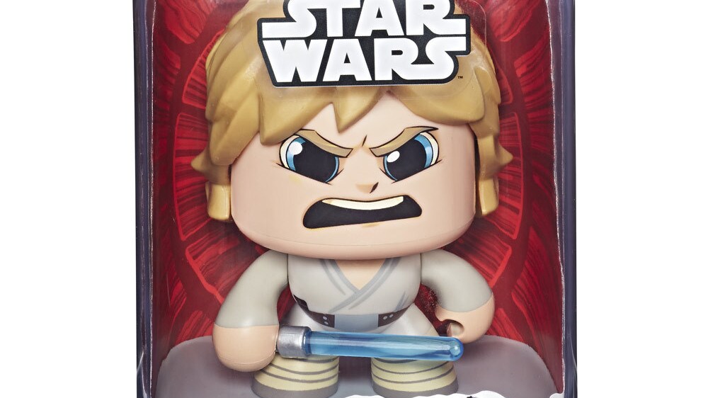 A packaged Luke Skywalker Star Wars Mighty Muggs collectible figure holds a lightsaber with an angry expression on its face.