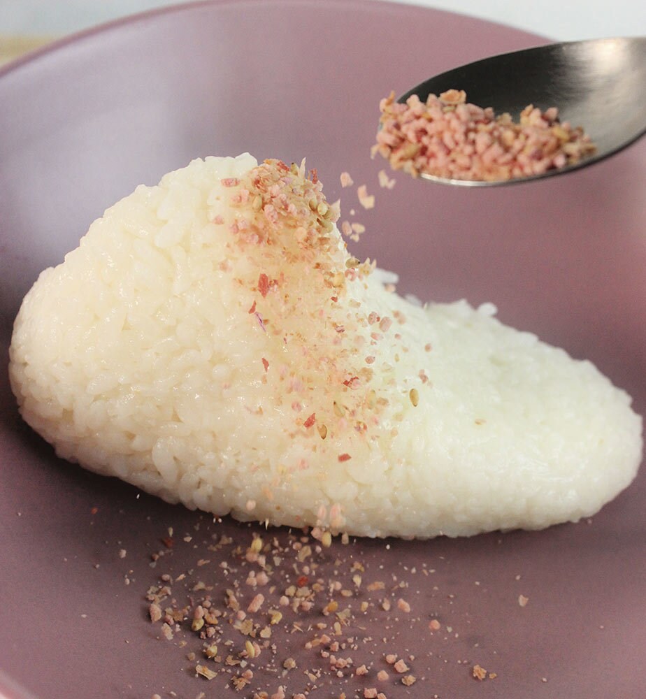 Pink furikake seasoning shaken onto the rice