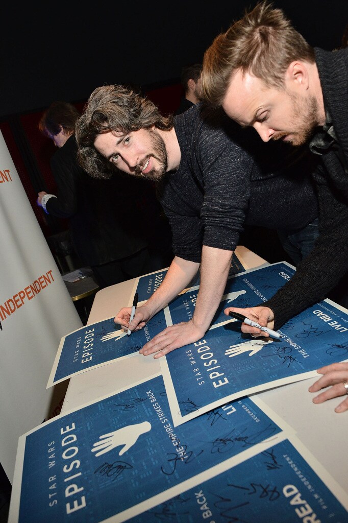 Film director Jason Reitman and actor Aaron Paul sign Star Wars Live Read posters.