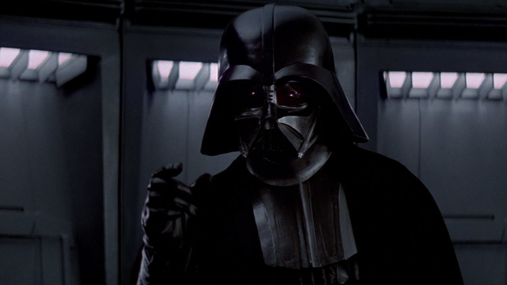Darth Vader raises his hand to force choke someone in A New Hope.