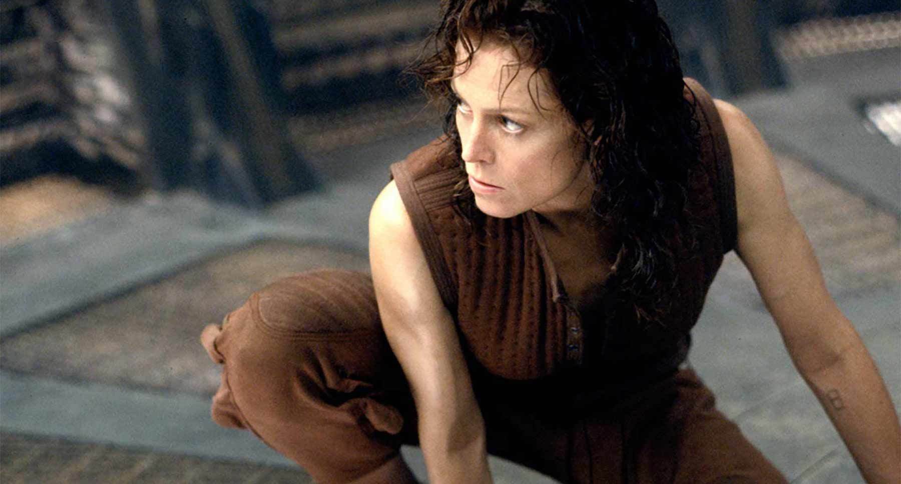 Actor Sigourney Weaver (as Ripley) crouching in the film "Alien: Resurrection"