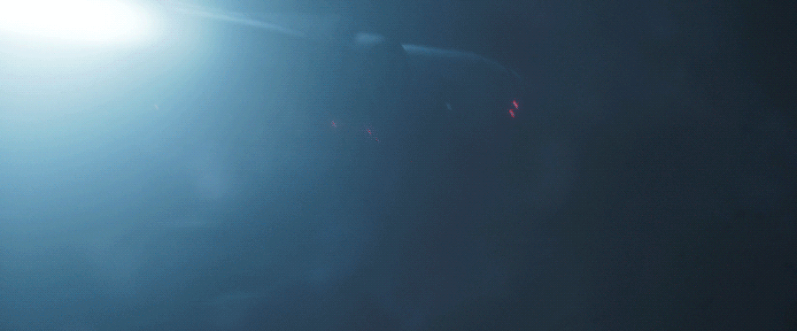 The Millennium Falcon flies through a space storm, in a GIF.