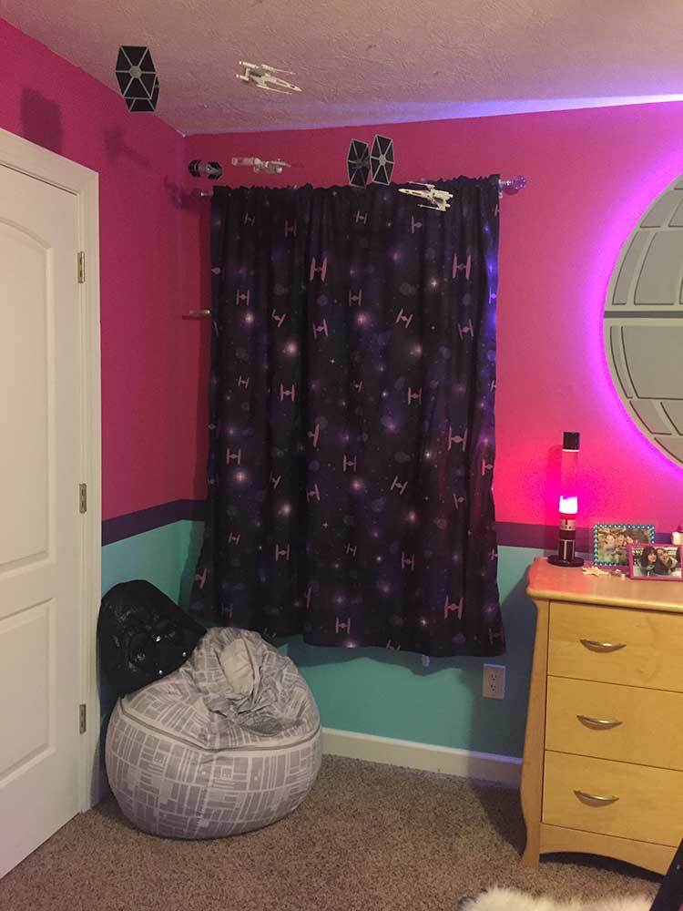 A Star Wars themed fan room with TIE Fighter curtains. A Darth Vader helmet sits atop a Death Star bean bag.