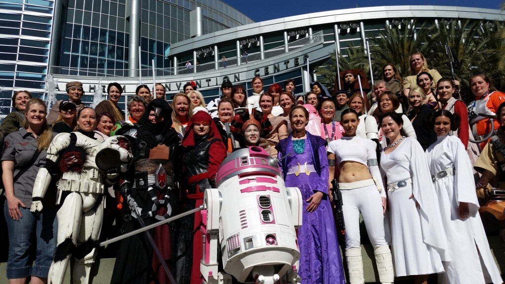 A large group of cosplayers gather behind R2-KT for a photo at Star Wars Celebration Anaheim.