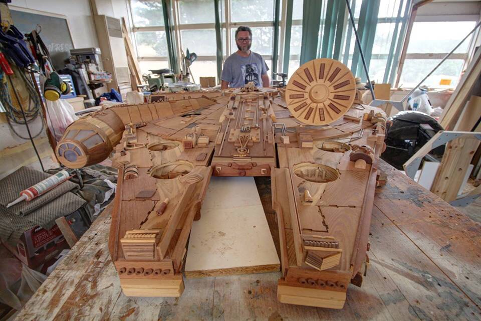 Martin Creaney poses with the wooden Millennium Falcon sculpture he made.