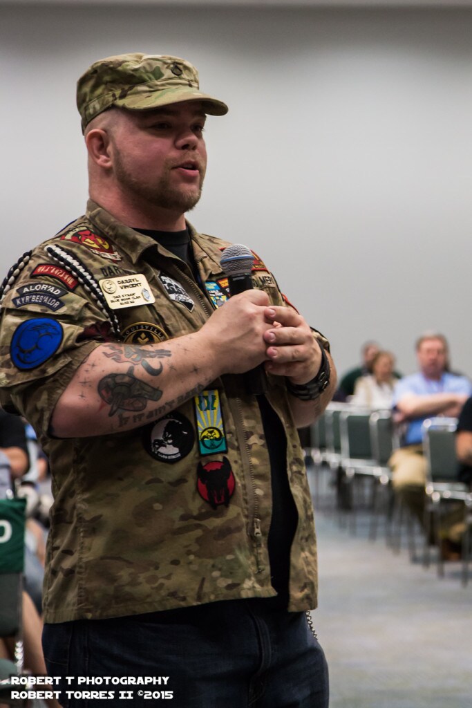 Darryl Vincent, an Afghanistan veteran, speaks at a microphone.