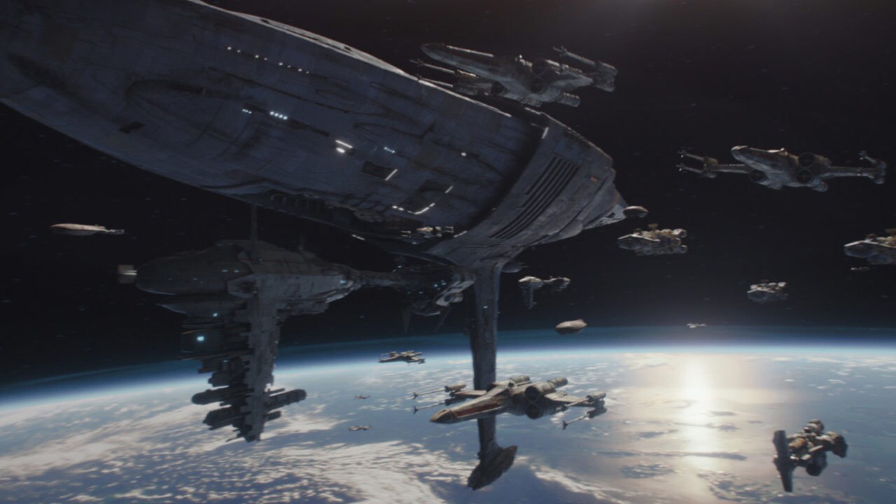 A Mon Calamari star cruiser in flight next to other Rebellion spaceships.