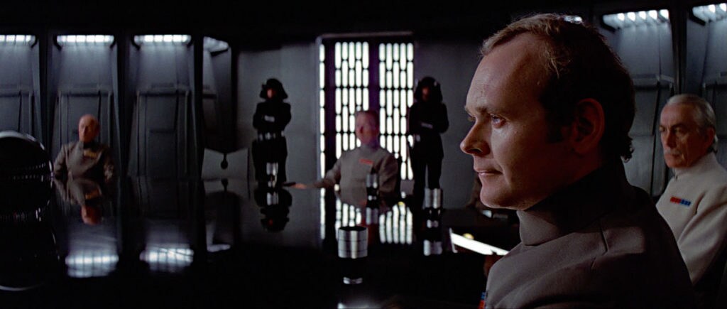 Admiral Motti at a table with other Empire commanders in Star Wars: A New Hope.