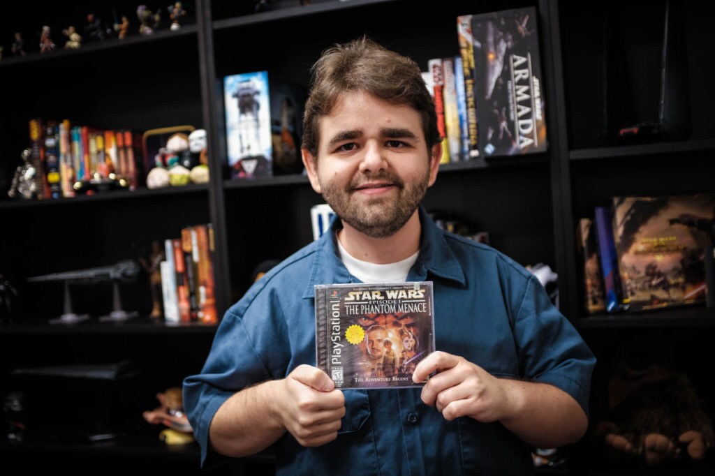 A member of the Lucasfilm Games Team holds up the box of Star Wars: Episode I - The Phantom Menace.
