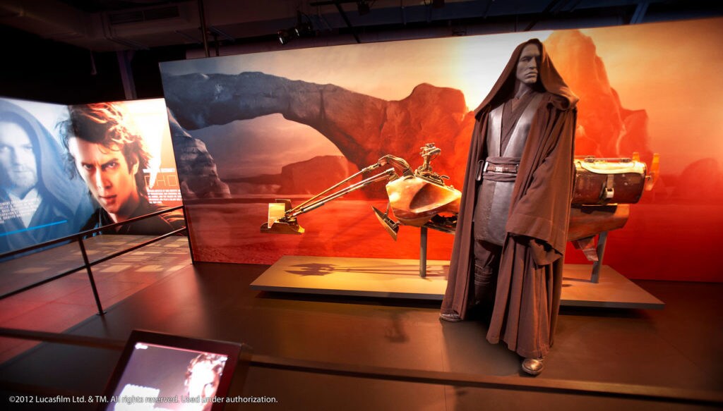 An Anakin Skywalker costume and speeder bike on display at the Star Wars Identities exhibit.