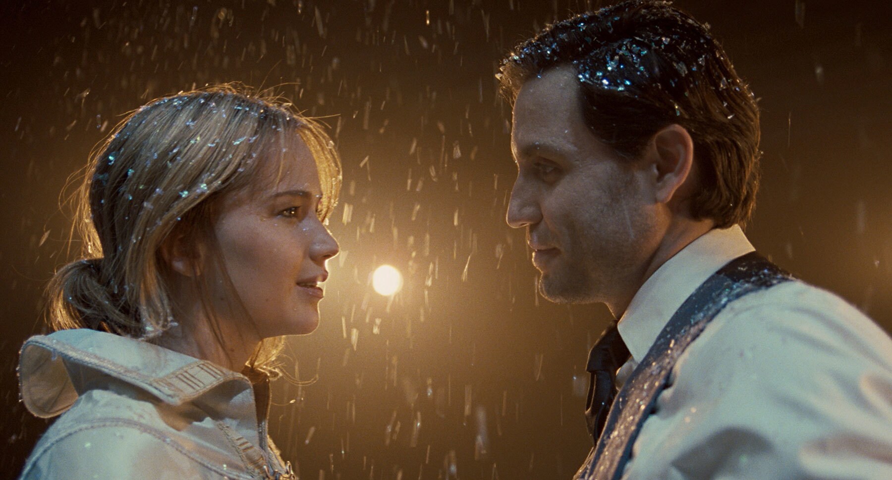 Edgar Ramírez (Tony) and Jennifer Lawrence (as Joy) standing in the snow in Joy