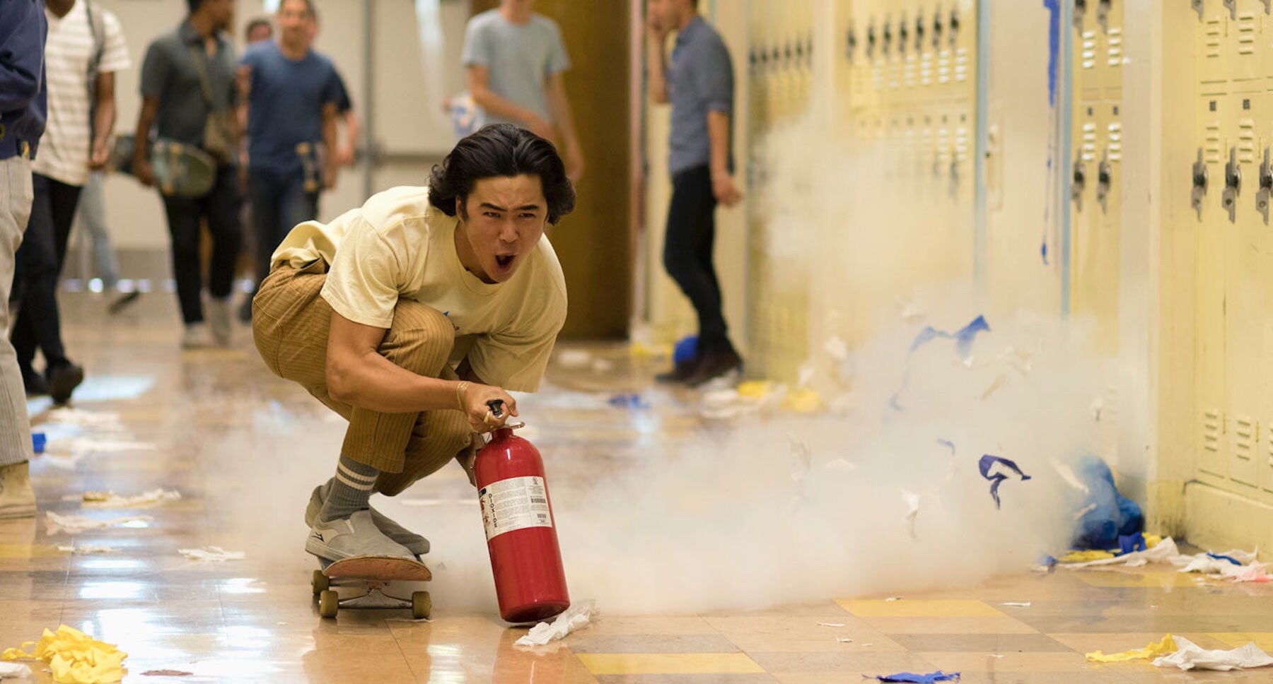 Actor Nico Hiraga (as Tanner) riding a skateboard propelled by a fire extinguisher down a school hallway  in the movie "Booksmart"