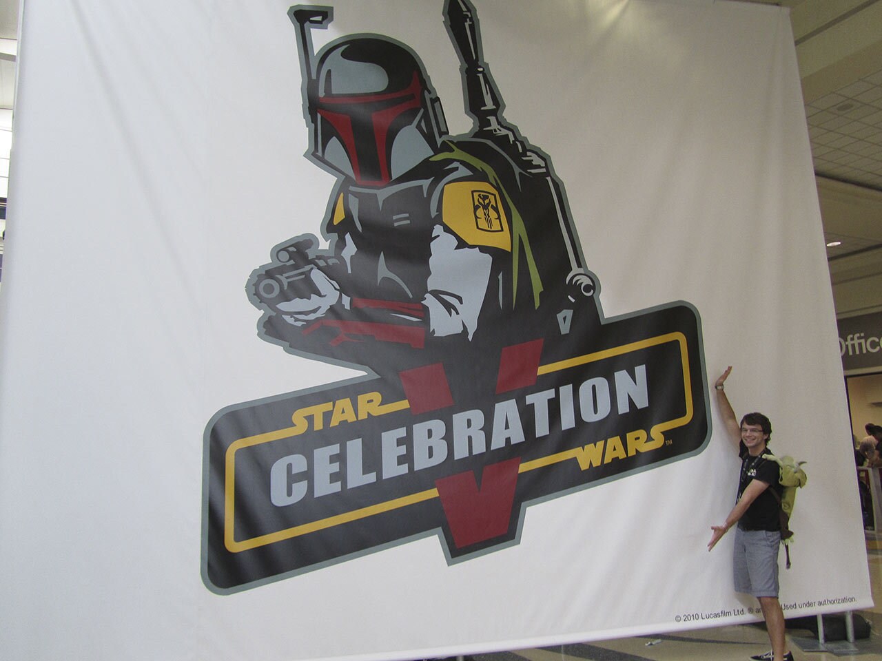 Dustin posing infront of the Star Wars: Celebration V logo