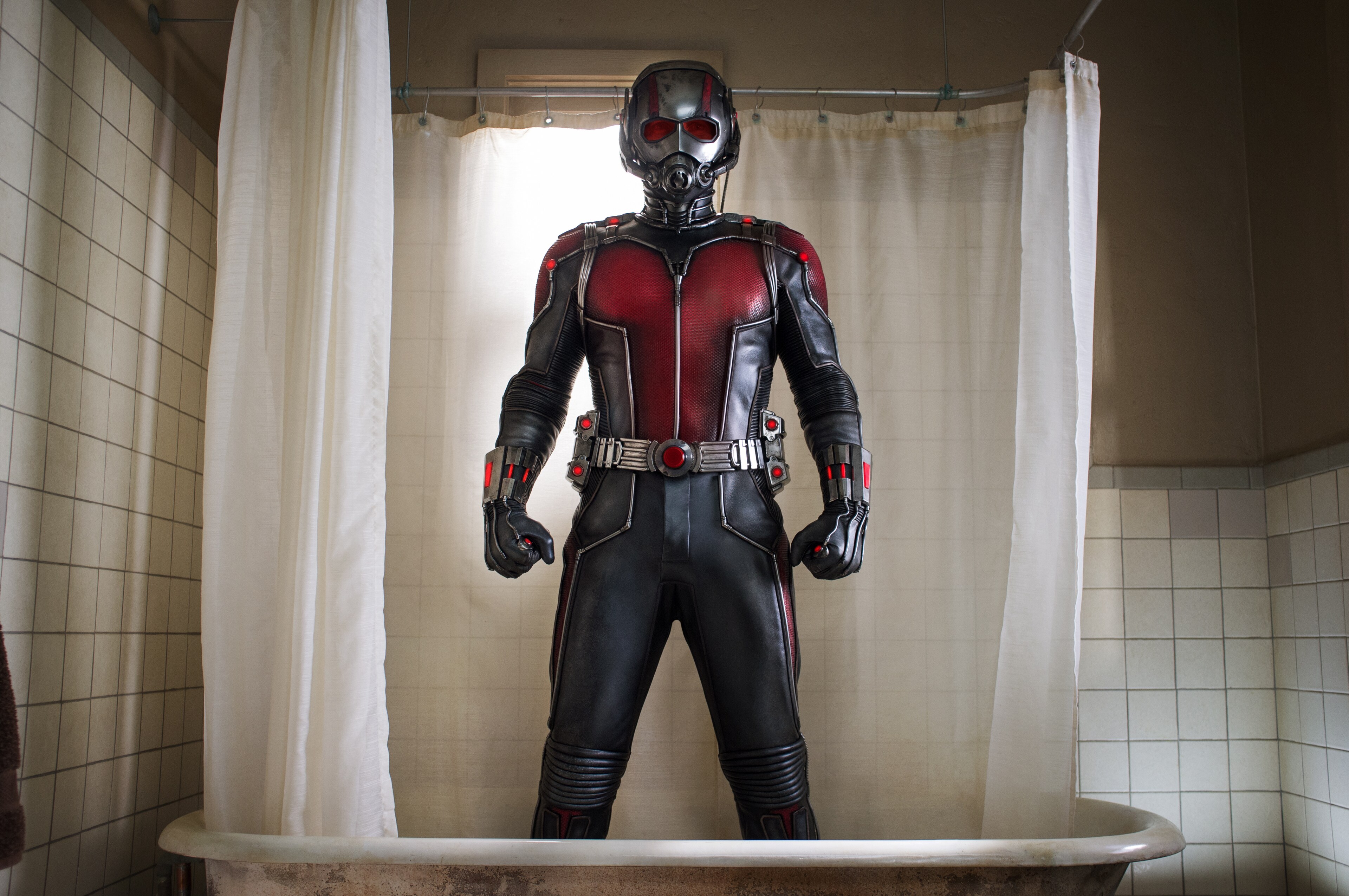 Paul Rudd (as Scott Lang) wearing Ant-Man suit standing in a tub