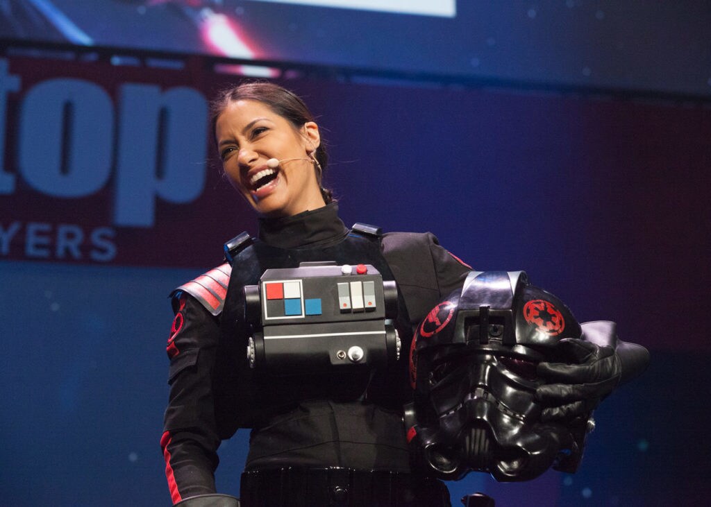 Actor and gamer Janina Gavankar, who plays Iden Versio in Star Wars Battlefront II, stands in costume and laughs.