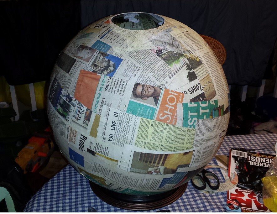 A newspaper-covered beach ball, to form the body of a BB-8 model.