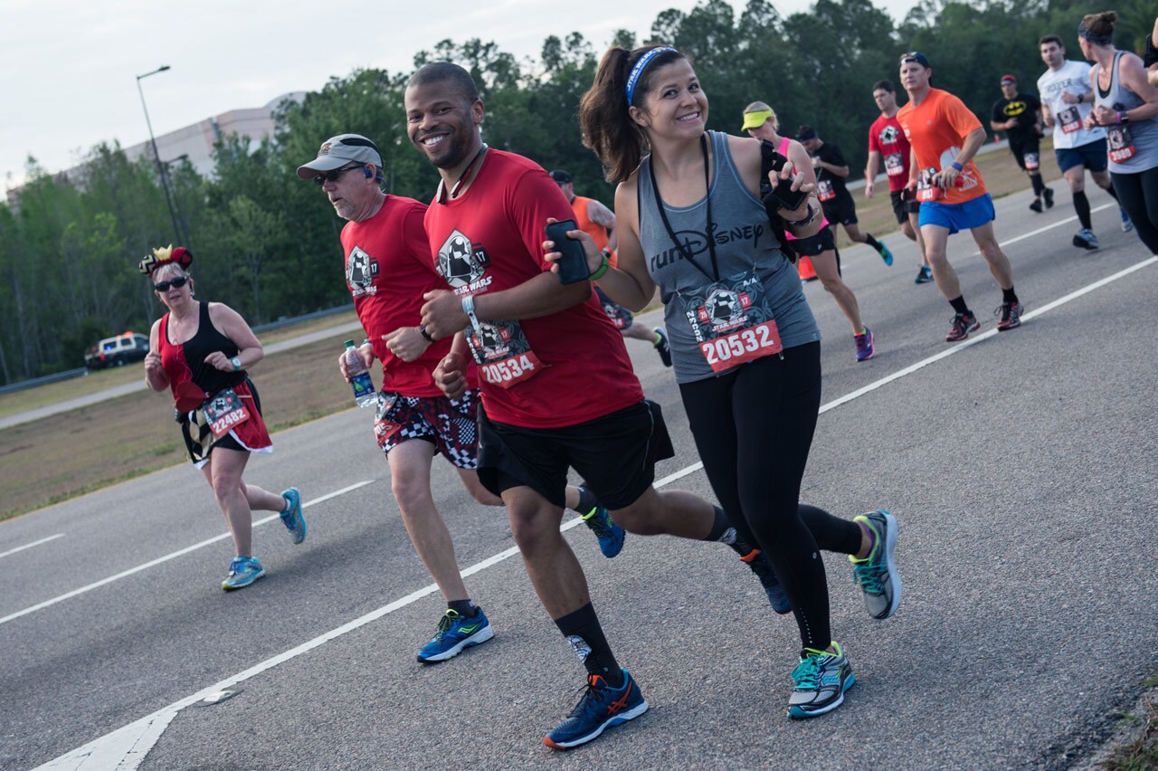 Runners smile at a runDisney Star Wars event.