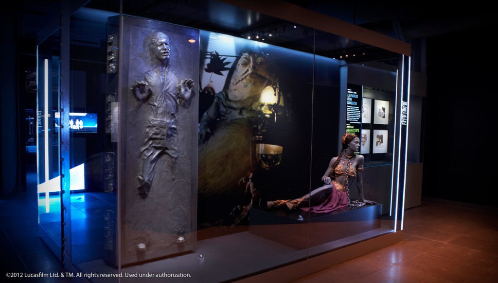 A Star Wars Identities exhibit with Han Solo in carbonite, Jabba the Hutt, and Leia's dancing-girl costume.