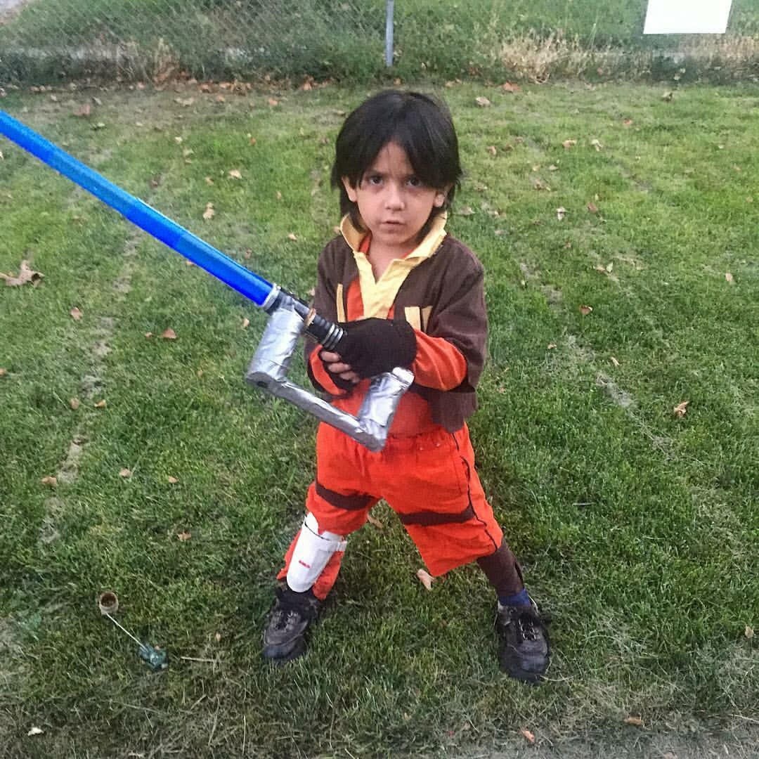 A young Star Wars fan wields a homemade lightsaber.