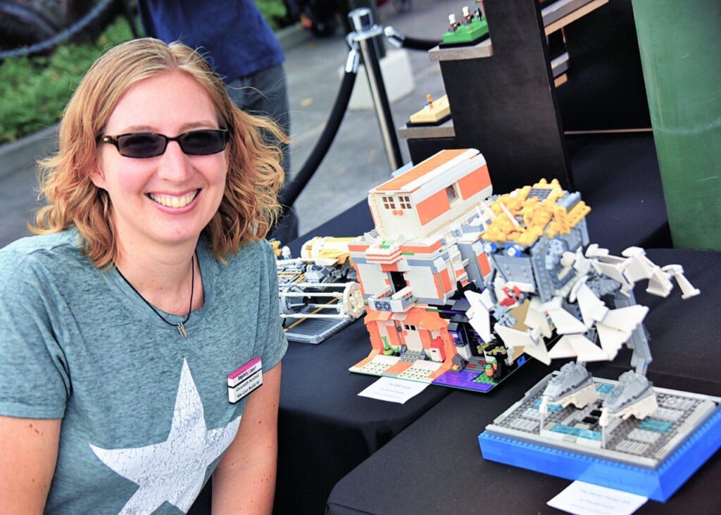 Lego Star Wars enthusiast Gwyneth Kozbial poses with models she built.