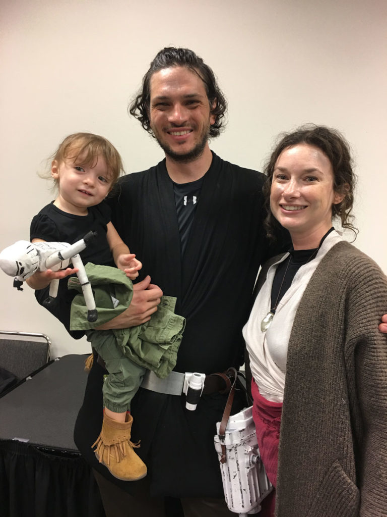 A family cosplays as Lyra, Galen, and young Jyn Erso.
