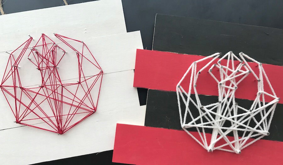 Two different string art crafts shaped like the Rebel insignia, in red and white colors.