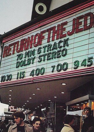 A theatrical marquee displays showtimes for Return of the Jedi.