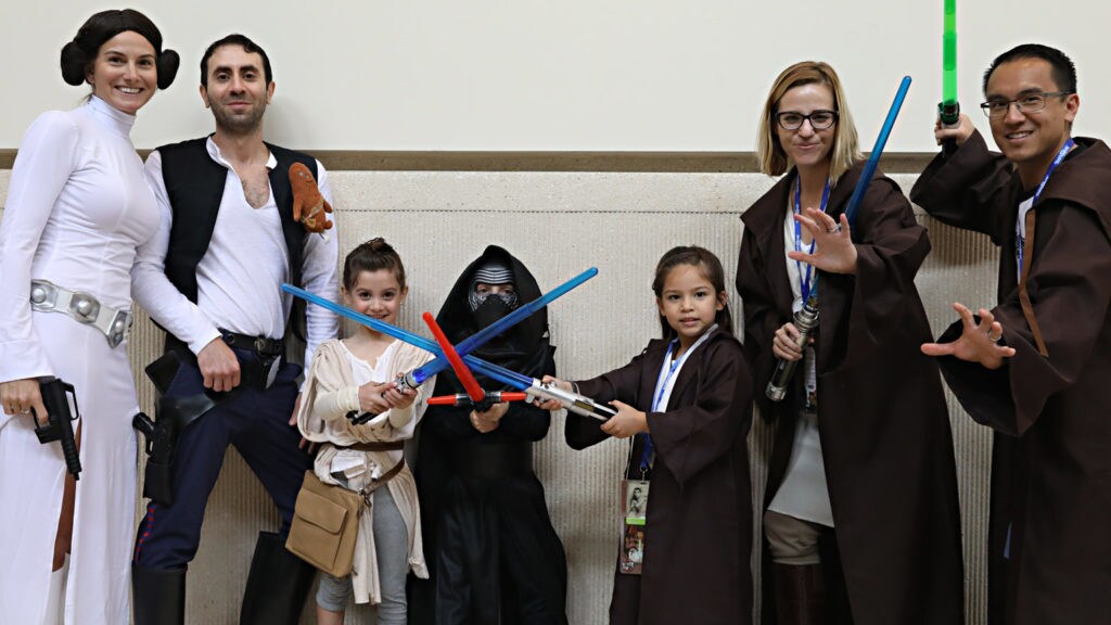 A group of adults and kids in Star Wars cosplay.