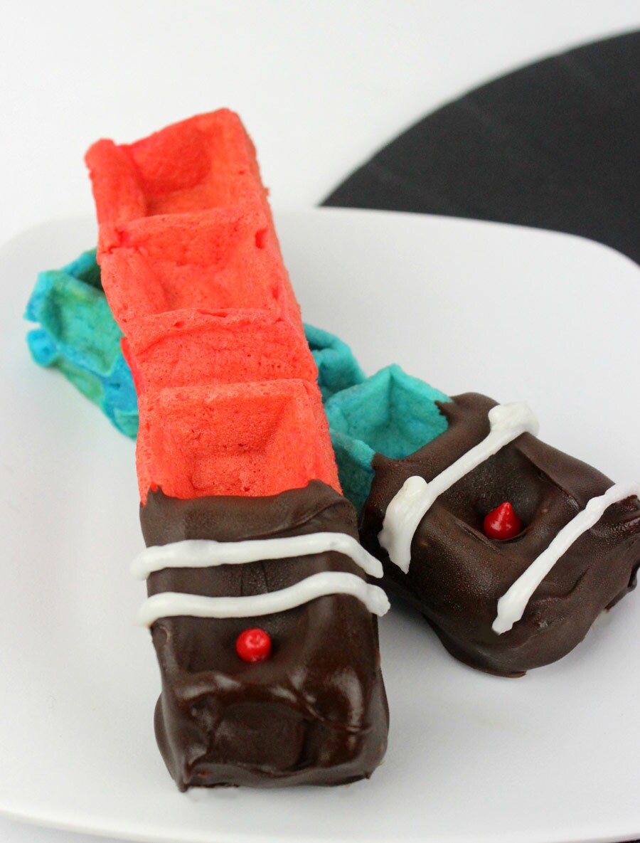 Crossed red and blue lightsaber waffle sticks.