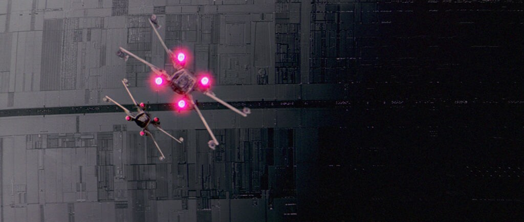 Two X-Wing starfighters fly toward the trench on the Death Star.