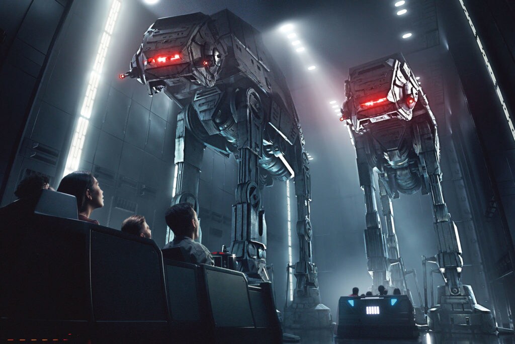 Two AT-ATs tower over park-goers in ride vehicles at the Rise of the Resistance attraction at Disney Park's Star Wars: Galaxy's Edge.