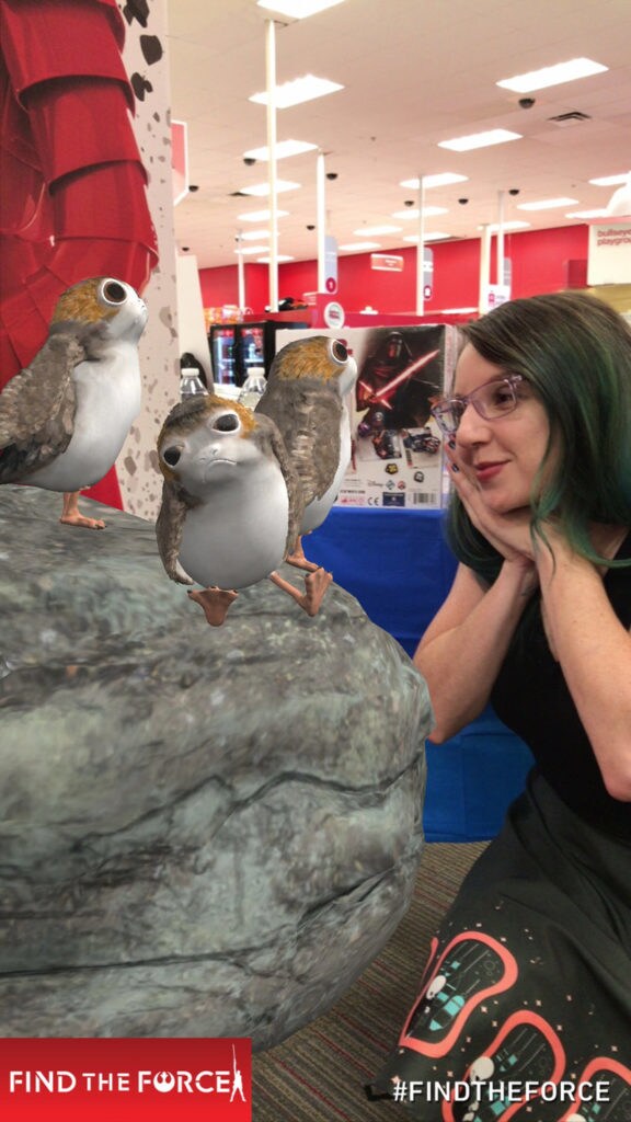 A Star Wars fans poses with augmented reality Porgs.