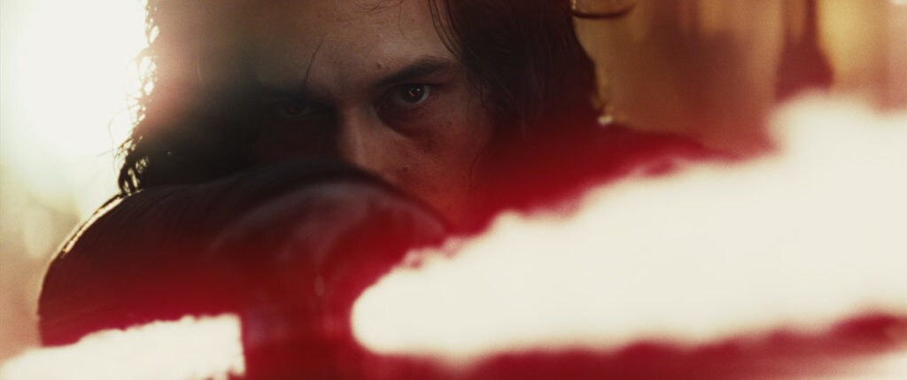 Kylo Ren holds a lightsaber.