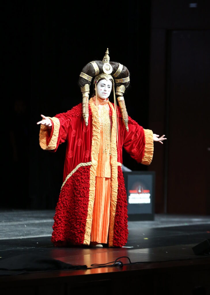 A cosplayer wears a homemade version of one of Queen Amidala's elaborate outfits from The Phantom Menace.