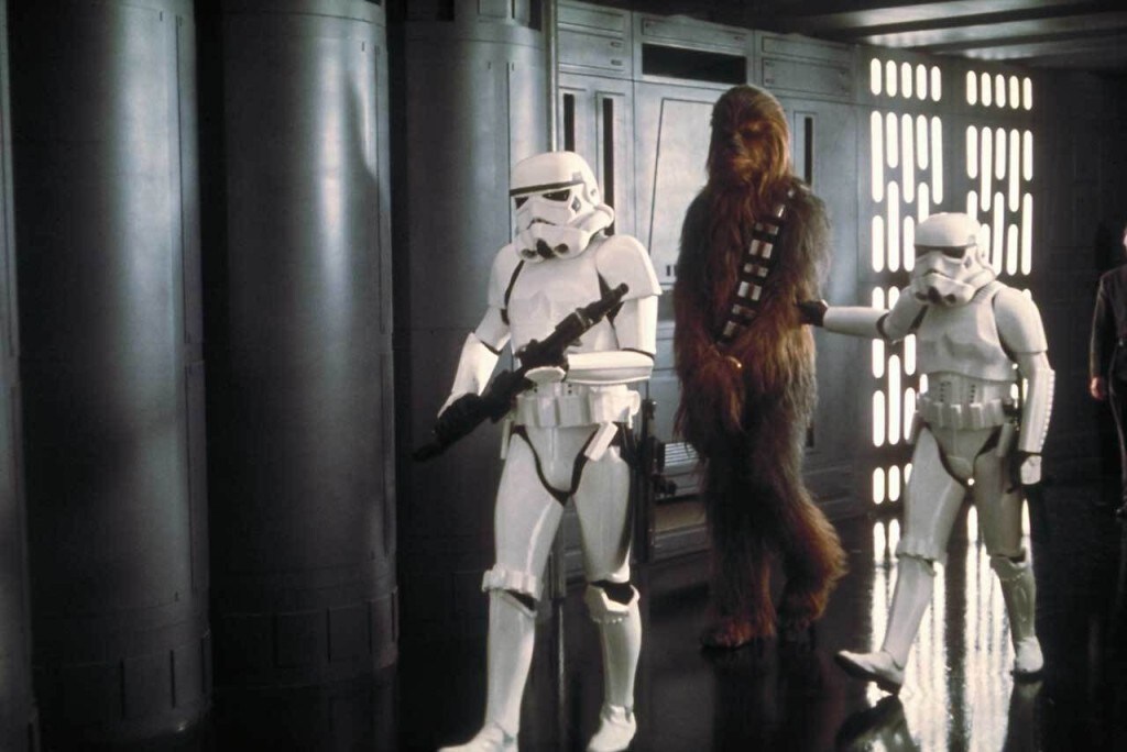 Stormtroopers escort a captive Chewbacca.