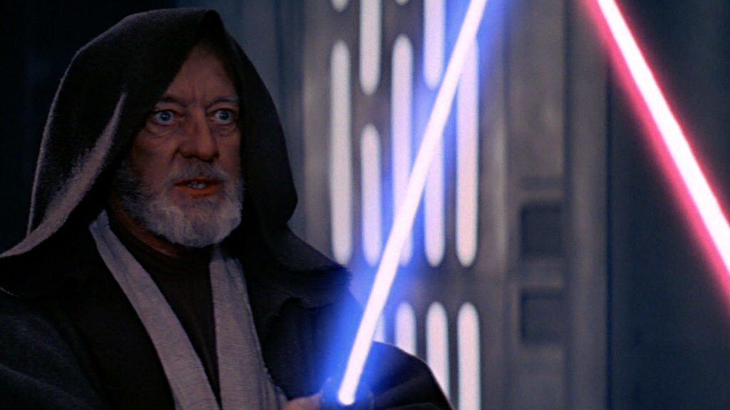 Obi-Wan with lightsaber raised in Star Wars: A New Hope.