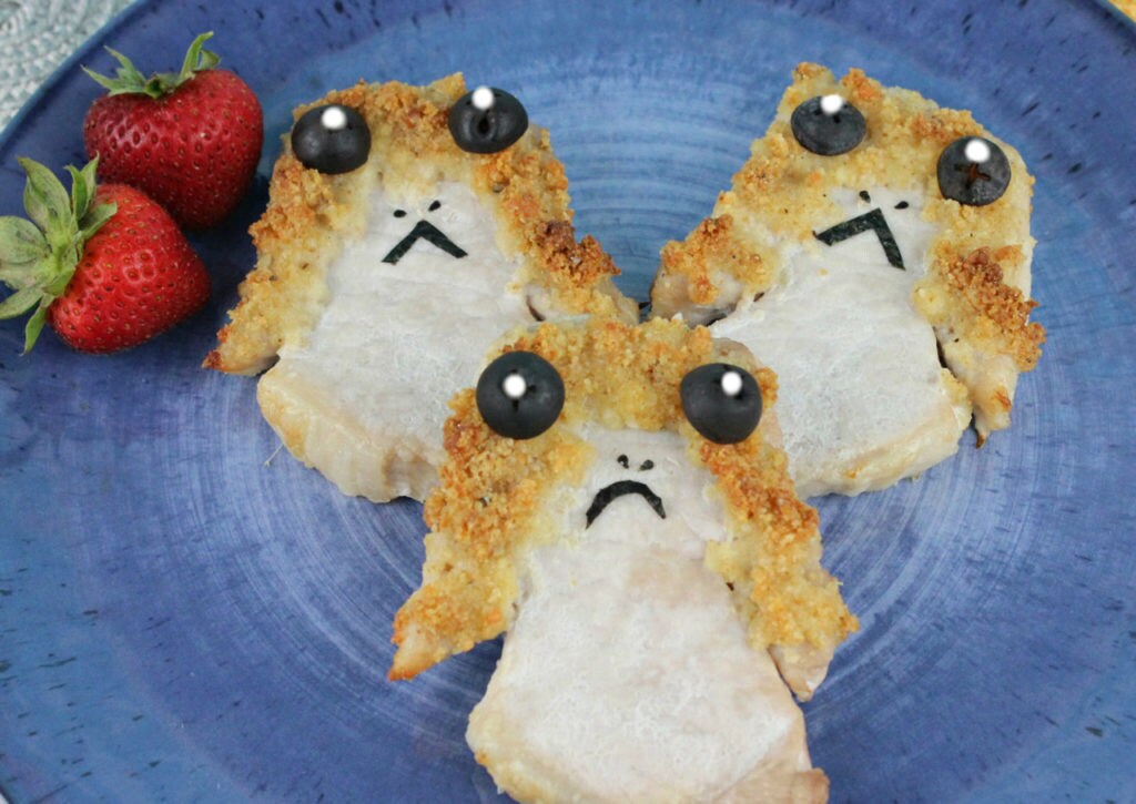Porg Chops on a blue plate with strawberries.