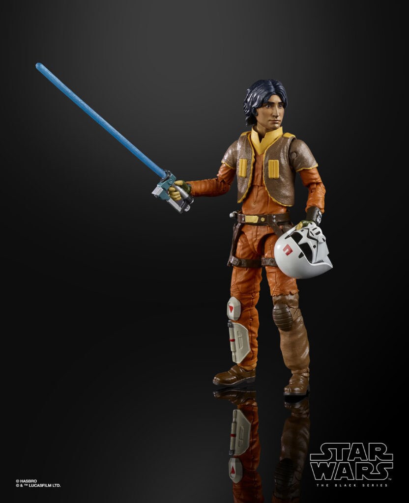 An Ezra Bridger Hasbro action figure in an orange jumpsuit, brown jacket, and with a lightsaber and helmet.