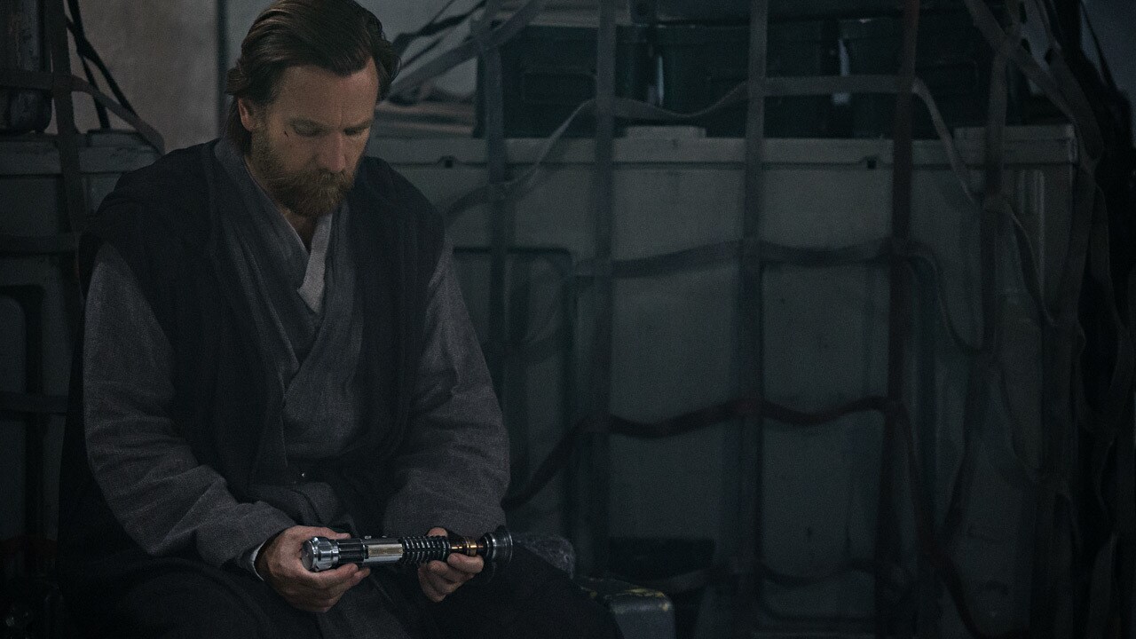 Obi-Wan looking down at his lightsaber
