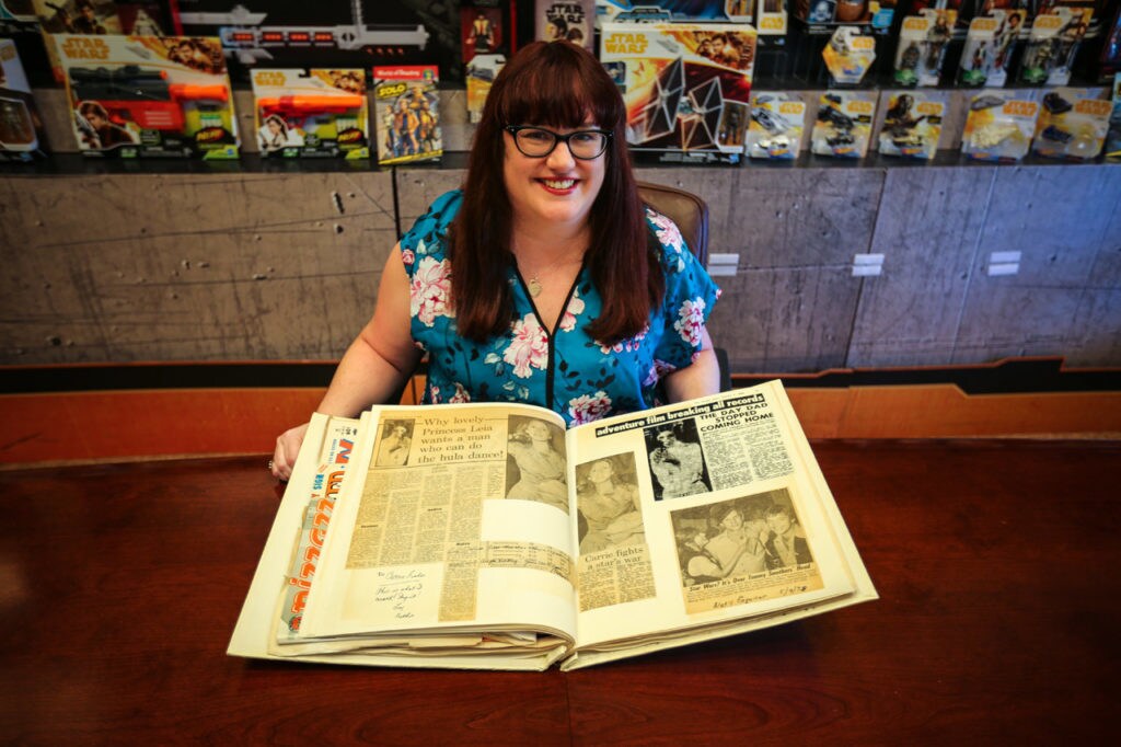 Lucasfilm's Jennifer Heddle with her scrapbook owned by Carrie Fisher.