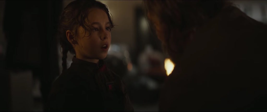 Jyn Erso, as a young girl, talks to her father Galen in a scene from Rogue One.