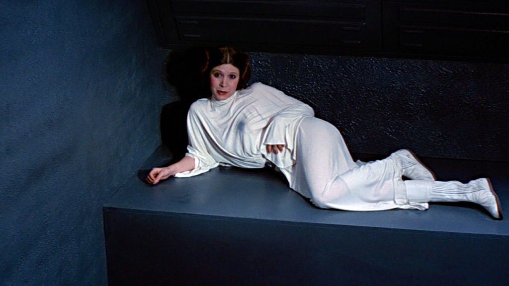 Princess Leia rests in her holding cell on the Death Star.